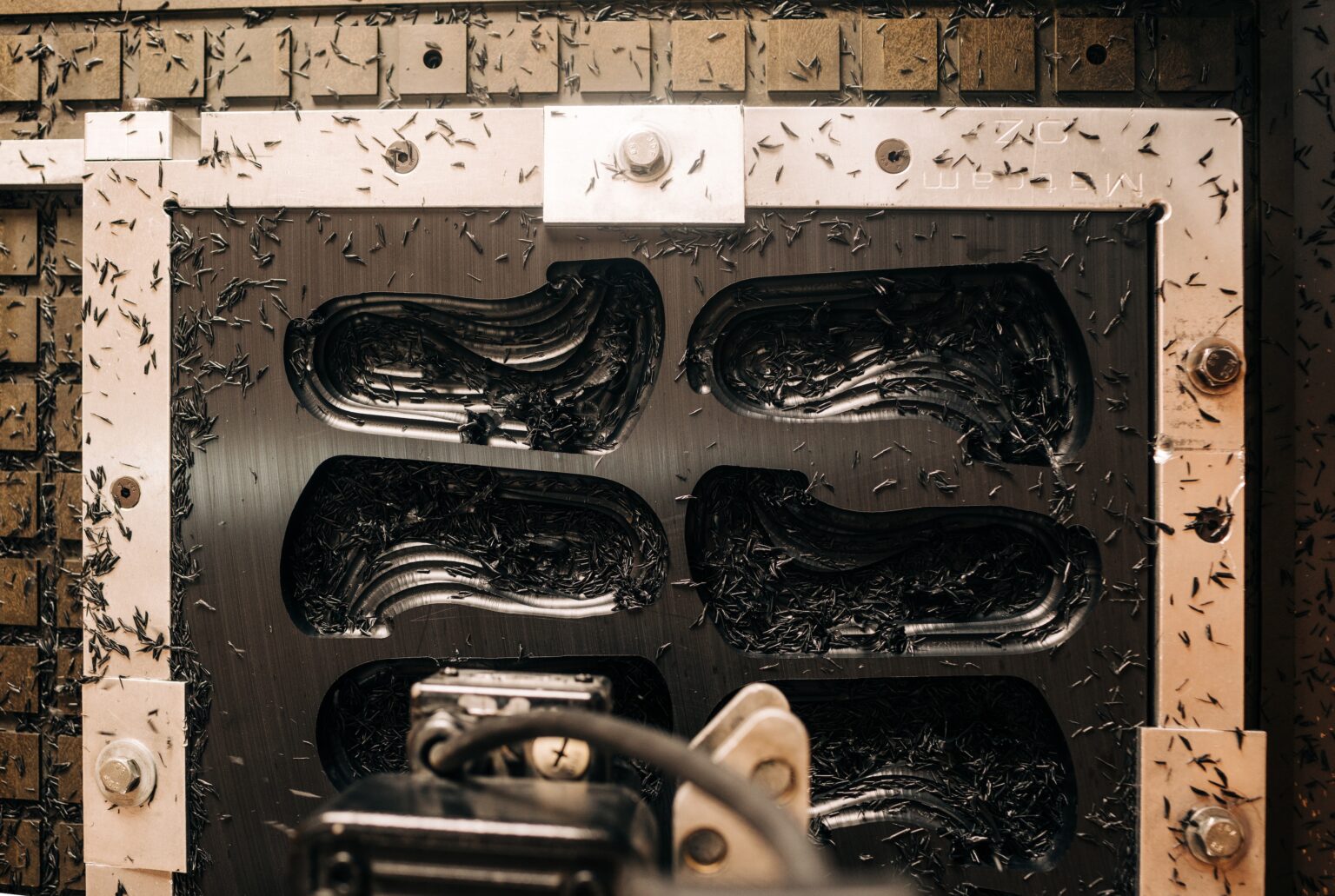 Orthotics being milled in the bed of the CNC machine