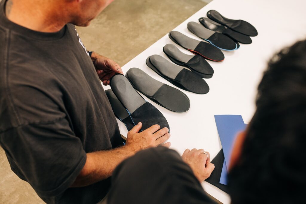 Finished custom orthotics laid out for inspection